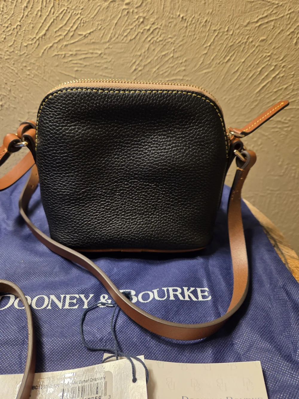 Dooney & Bourke NWT Black Pebble Leather Crossbody with Brown Trim. Logo charms